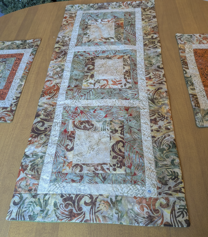Moss & Tan Batik Table Runner,Batik Table Runner,best hand-quilted batik table runner, earth tone dining room decor ideas,Everyday table runner, hand-quilted cotton table runner,handcrafted earth tone batik table linens, handmade batik kitchen table linens,handmade quilted table runners,Handmade table linens,Handmade Table Runner, modern quilted table runners,patchwork table runner,Quilted Table Runner,rustic moss green and rust dining runner,Table runner for glass table,Table runner for kitchen island,Table setting,Unique table runner